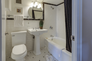 a bathroom with a white toilet, sink, and tub