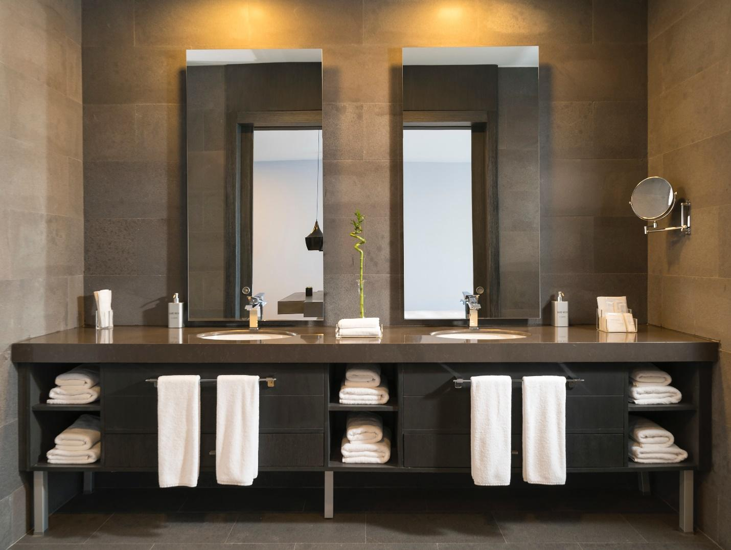 a modern bathroom with black drawers under the sink